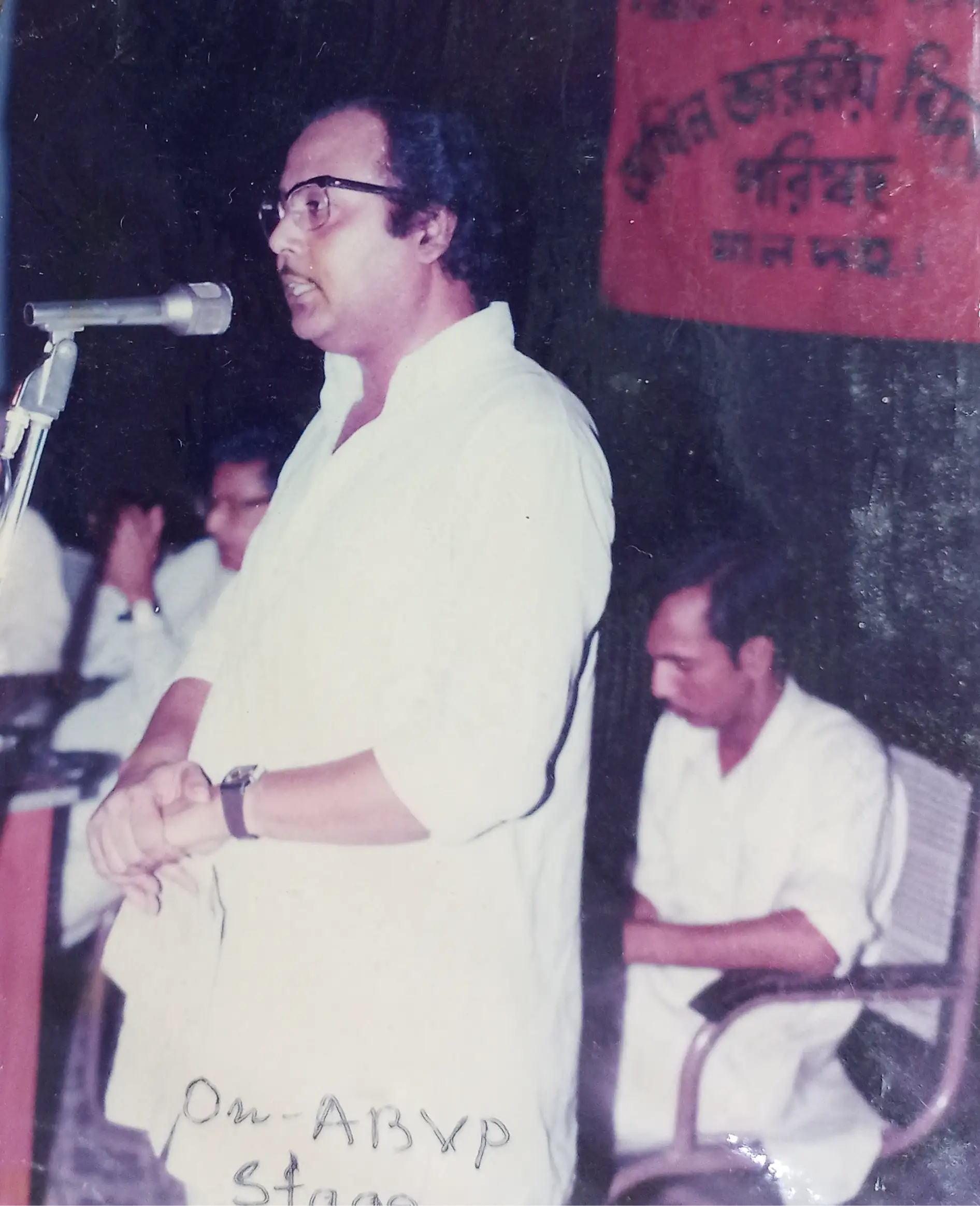 This is an image of Dr. Gopesh giving a speech to students on the stage of the Akhil Bharatiya Vidyarthi Parishad (ABVP) organisation affiliated to Rashtriya Swayamsevak Sangh (RSS).